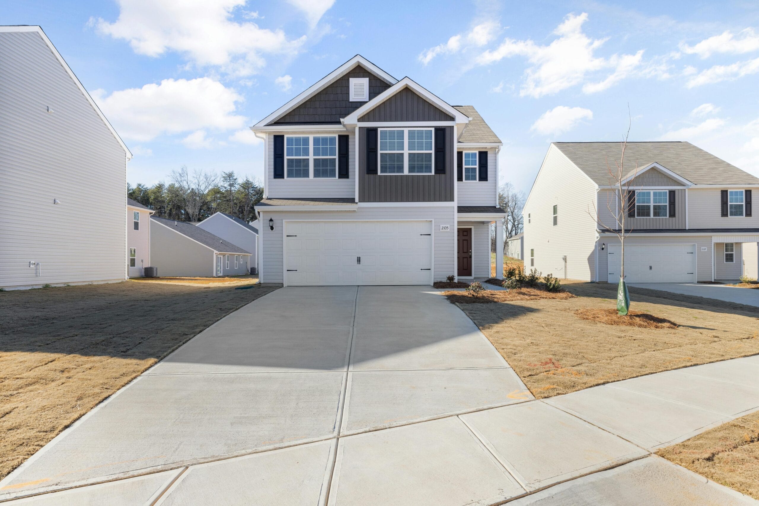 Spacious two-story house with a modern facade in a suburban neighborhood.